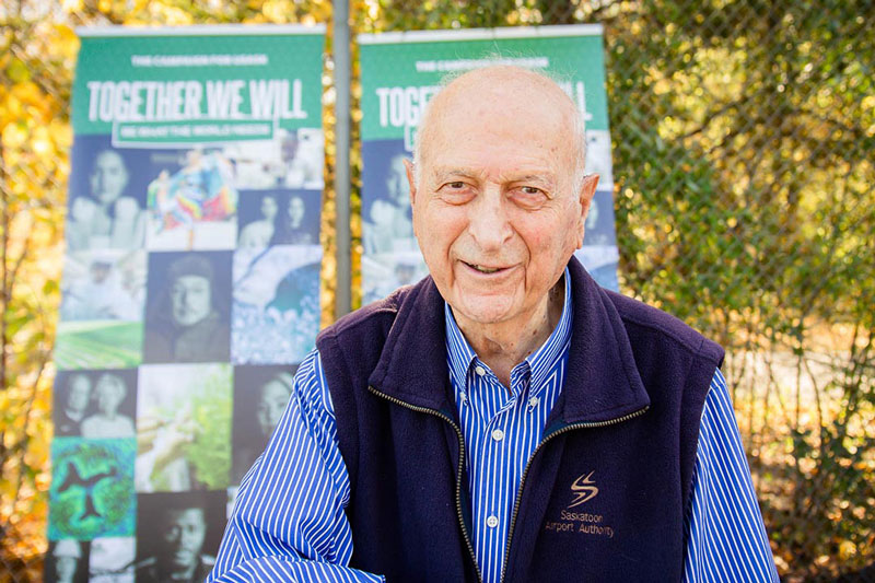 Dr. Nasser standing in front of the tennis courts.